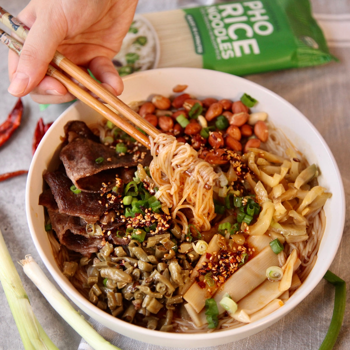 A steaming bowl of Guilin Rice Noodles with fresh toppings