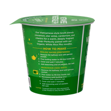 Load image into Gallery viewer, A cup of Lotus Foods Vietnamese Vegetable Pho Noodle Soup Cup (back of package) on a pale mint green background with a subtle wave pattern.
