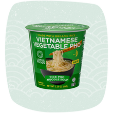 Load image into Gallery viewer, A cup of Lotus Foods Vietnamese Vegetable Pho Noodle Soup Cup on a pale mint green background with a subtle wave pattern.
