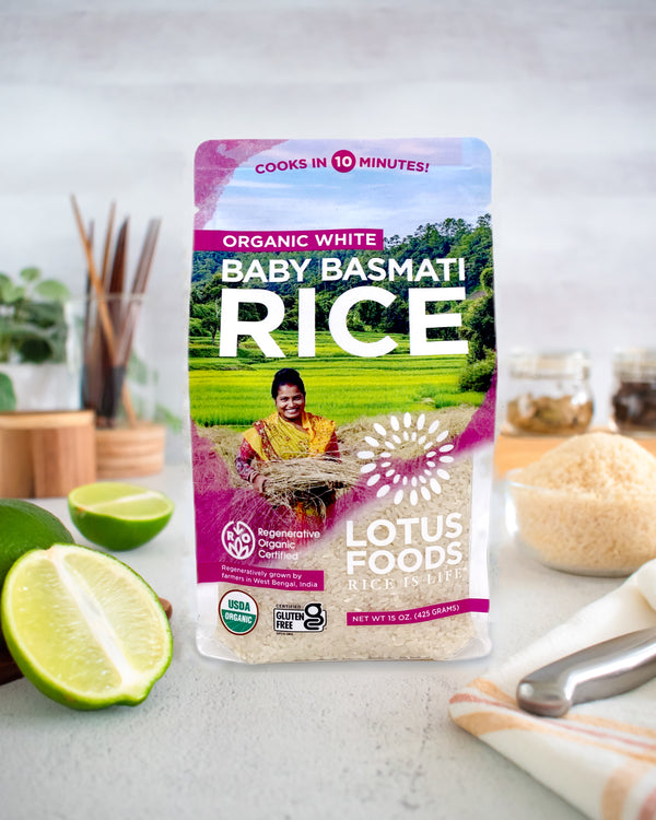 Package of Lotus Foods Baby Basmati Rice on a kitchen counter with limes and a bowl in the background.